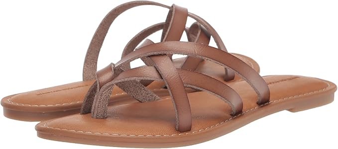 Flat brown strappy sandals with simple crossover design, ideal for beach or casual wear.